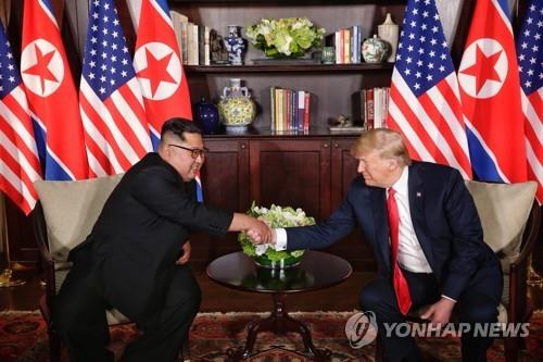 A file photo shows U.S. President Donald Trump (R) shaking hands with North Korean leader Kim Jong-un in Singapore on June 12, 2018. (Yonhap)