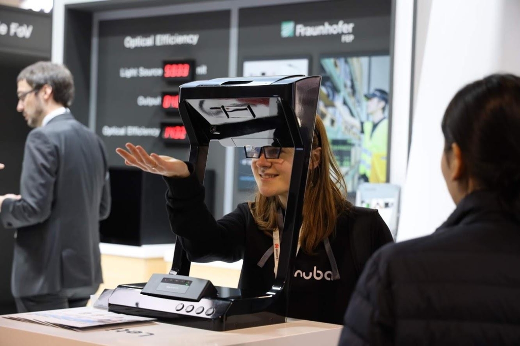 A visitor to LetinAR's exhibition booth at MWC Barcelona experiences its AR display, in this photo provided by the company on March 13, 2019. (Yonhap)