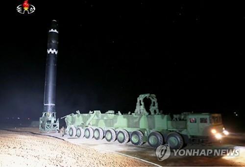This photo captured from North Korea's Korean Central Television on Nov. 30, 2017, shows an intercontinental ballistic missile being placed into an upright position on a mobile launcher the previous day. North Korea has said it has successfully test-fired the new missile, called the Hwasong-15, and that it can reach anywhere in the United States. (For Use Only in the Republic of Korea. No Redistribution) (Yonhap)