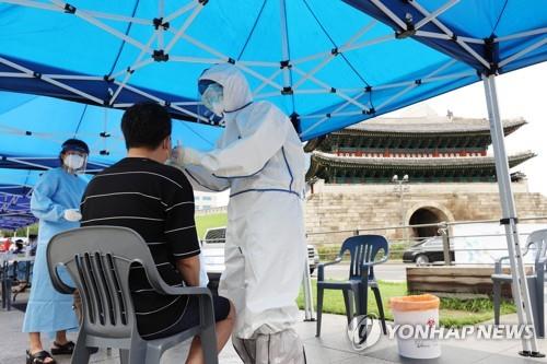 A citizen gets tested for the coronavirus at a makeshift testing facility near Namdaemun Market in central Seoul on Aug. 10, 2020. (Yonhap)