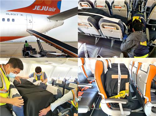 This file photo taken on Oct. 22, 2020, and provided by Jeju Air shows the carrier's employees loading cargo on the seats of a B737-800 passenger jet on the Incheon-Bangkok route at Incheon International Airport in Incheon, just west of Seoul. (Yonhap)