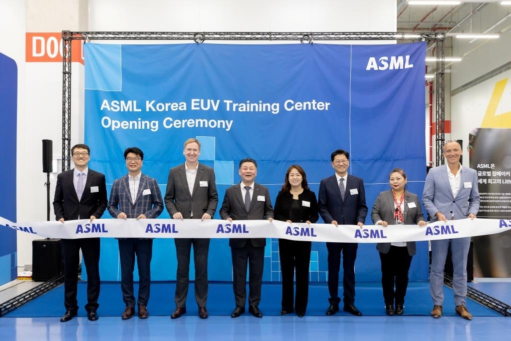 The photo, provided by ASML Korea on May 18, 2023, shows ASML employees at the opening ceremony of a new EUV training center in Yongin, 42 kilometers south of Seoul. (PHOTO NOT FOR SALE) (Yonhap)