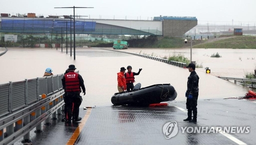 A rescue operation is under way on a submerged road in Cheongju, North Chungcheong Province, on July 15, 2023. (Yonhap)