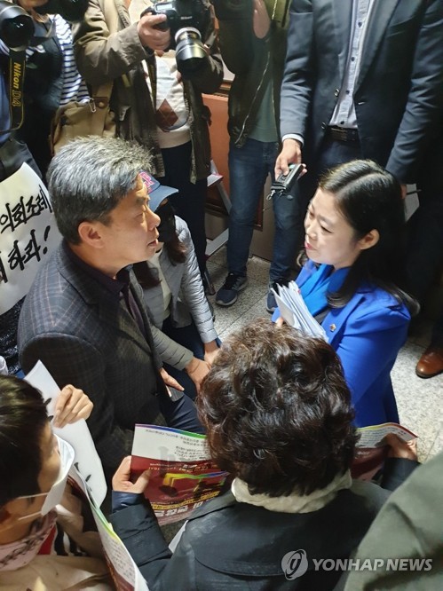 무릎 꿇고 이야기하는 시의원과 학부모