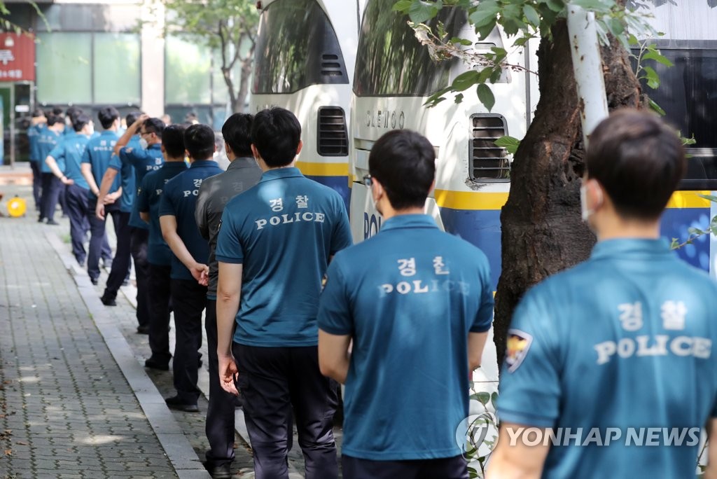 Police officers stand in line at a COVID-19 testing center in Seoul's central Jung Ward on Aug. 19, 2020. (Yonhap)