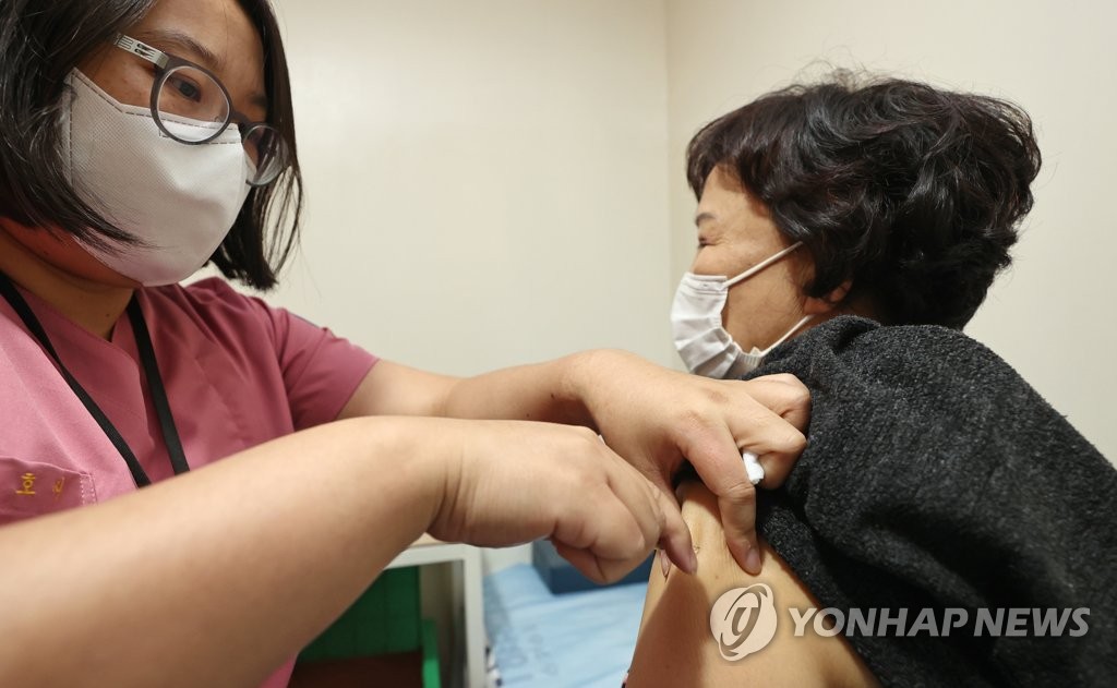 This photo, taken on Oct. 26, 2020, shows a woman getting a seasonal flu shot at a clinic in Seoul. (Yonhap)