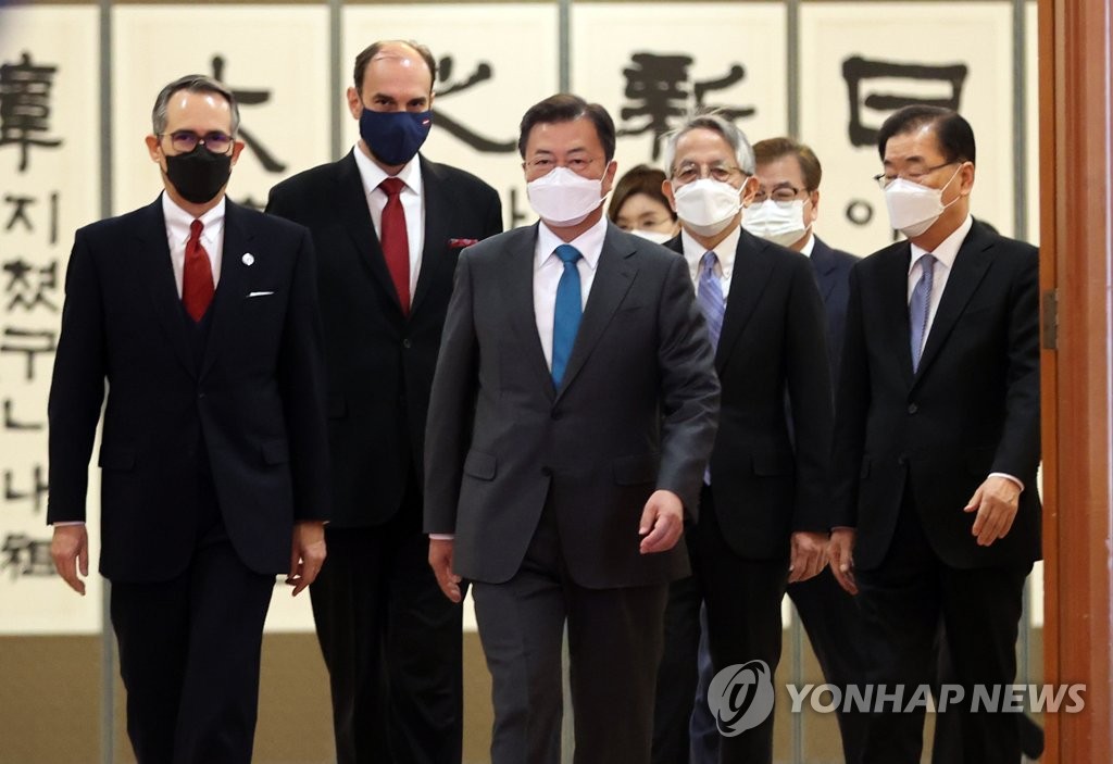 South Korean President Moon Jae-in (C) walks toward a meeting room at Cheong Wa Dae in Seoul after receiving credentials from the new ambassadors of Japan, Dominica and Latvia. (Yonhap)