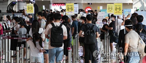 거리두기 안내판 아래 여행객들