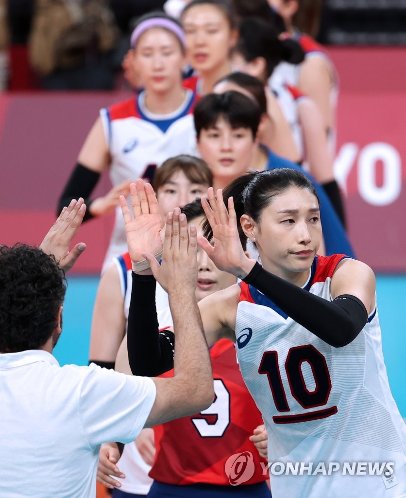 South Korean players and coaches high-five each other after their straight-set loss to Brazil in the semifinals of the Tokyo Olympic women's volleyball tournament at Ariake Arena in Tokyo on Aug. 6, 2021. (Yonhap)