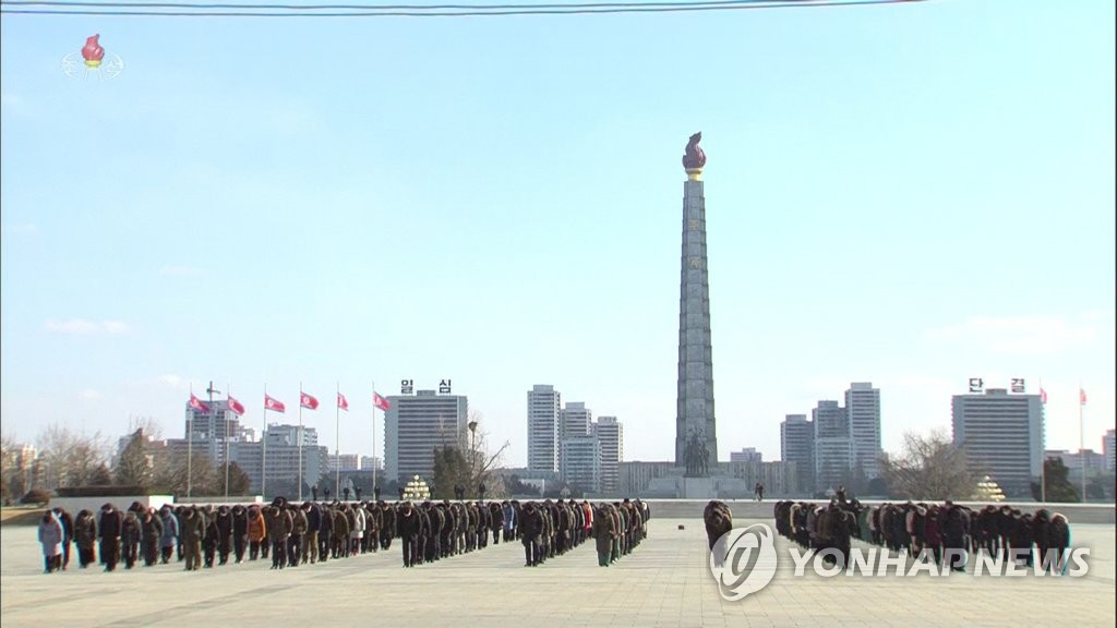 In this photo, captured from North Korea's Korean Central Broadcasting Station, citizens pay a silent tribute to former leader Kim Jong-il in Pyongyang on the 10th anniversary of his death on Dec. 17, 2021. (For Use Only in the Republic of Korea. No Redistribution) (Yonhap)