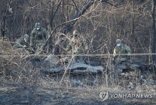 추락 전투기 잔해 조사하는 군 관계자