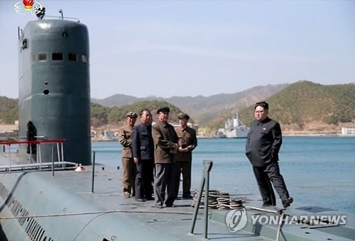 North Korean leader Kim Jong-un (R) is aboard a submarine in this photo released by the North's Rodong Sinmun newspaper on April 24, 2016, watching the launch of a submarine-launched ballistic missile (SLBM). (For Use Only in the Republic of Korea. No Redistribution) (Yonhap) 