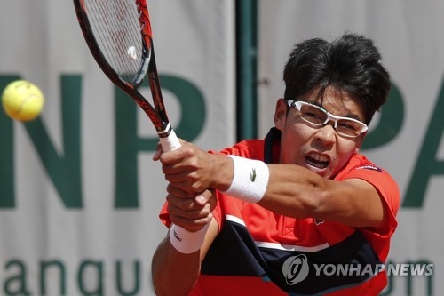 In this Associated Press photo, Chung Hyeon of South Korea hits a shot against Kei Nishikori of Japan during their third round match at the French Open at Roland Garros, Paris, on June 4, 2017. (Yonhap)