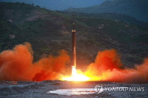 This photo carried by North Korea's Rodong Sinmun newspaper on May 15, 2017, shows the North's firing of a new intermediate-range ballistic missile, called the Hwasong-12. (For Use Only in the Republic of Korea. No Redistribution) (Yonhap)