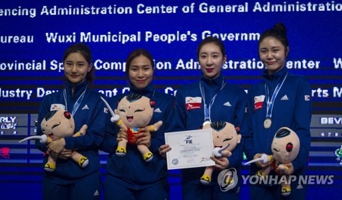 In this EPA file photo from July 25, 2018, South Korean epee fencers celebrate their silver medal in the women's team event at the 2018 World Fencing Championships in Wuxi, China. From left are Choi In-jeong, Kang Young-mi, Shin A-lam and Lee Hye-in. (Yonhap)