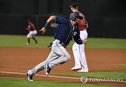 In this Getty Images file photo from July 8, 2018, Carlos Asuaje of the San Diego Padres rounds the third base on a double by Eric Hosmer against the Arizona Diamondbacks during the top of the first inning of a Major League Baseball regular season game at Chase Field in Phoenix, Arizona. Asuaje has signed with South Korean club Lotte Giants. (Yonhap)