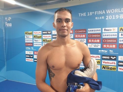 Eritrean swimmer Daniel Christian poses for photos after competing in the men's 100m butterfly preliminary at the FINA World Championships at Nambu University Municipal Aquatics Center in Gwangju, 330 kilometers south of Seoul, on July 26, 2019. (Yonhap)
