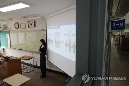 A teacher records a lecture for online education at a high school in Seoul on March 31, 2020, as the education ministry decided to open schools in stages from April 9, with online classes for middle and high school senior students first.