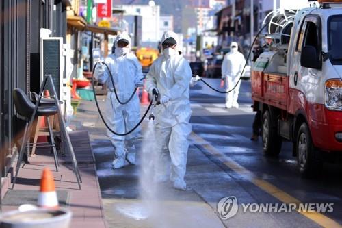 Officials carry out disinfection work on a street in Inje, Gangwon Province, on Nov. 12, 2020, in this photo provided by the provincial government. (PHOTO NOT FOR SALE) (Yonhap)