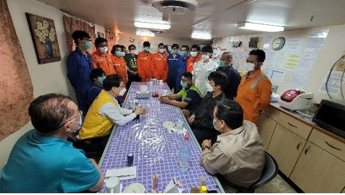 In this photo provided by Seoul's foreign ministry on Feb. 4, 2021, officials from the South Korean Embassy in Iran meet with the crew members detained aboard the Korean-flagged MT Hankuk Chemi oil tanker that has been seized by Iran since early last month. The meeting came a day after Tehran announced it will allow the sailors to leave the ship, except for the captain for management reasons. It remains unclear how many of them expressed a desire to leave the ship. (PHOTO NOT FOR SALE) (Yonhap)