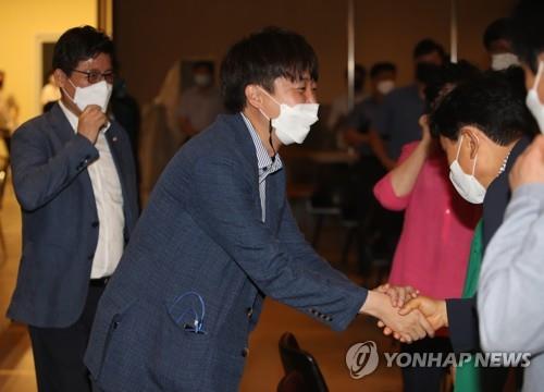 People Power Party Chairman Lee Jun-seok greets party members during his meeting with a regional council in Gumi, North Gyeongsang Province, on Aug. 10, 2021. 