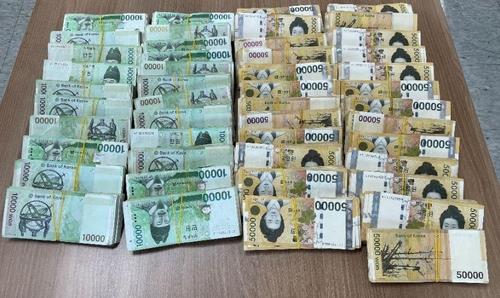 This photo provided by the Busan Metropolitan Police Agency on Oct. 25, 2021, shows cash seized from sex trafficking suspects. (PHOTO NOT FOR SALE) (Yonhap)