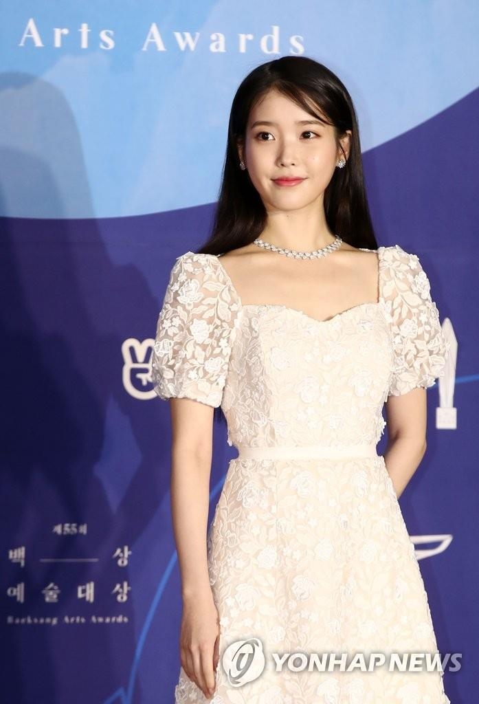 In this file photo, singer-actress IU poses for photos at the 55th Baeksang Arts Awards held at COEX, southern Seoul, on May 1, 2019. (Yonhap)
