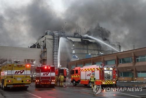 This Jan. 24, 2022, photo provided by Ulsan Fire Department shows firefighters putting out a blaze that broke out at a synthetic fiber manufacturing factory of Hyosung TNC Corp. in the southeastern city of Ulsan the previous day.