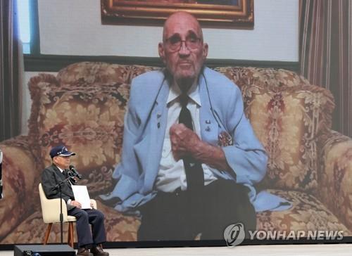 This undated file photo shows retired U.S. Army Col. William E. Weber delivering a video message at a gathering. (Yonhap)