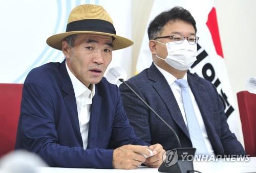 Lee Rae-jin (L), the elder brother of Dae-joon, a fisheries ministry official shot to death by North Korean soldiers while drifting in waters in the West Sea in September 2020, speaks during a meeting arranged by the ruling People Power Party (PPP) at the National Assembly in Seoul on June 24, 2022.