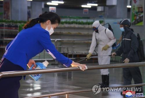 This file photo, released by the North's Korean Central News Agency on June 28, 2022, shows officials sterilizing an underground shopping center in Pyongyang. (For Use Only in the Republic of Korea. No Redistribution) (Yonhap)