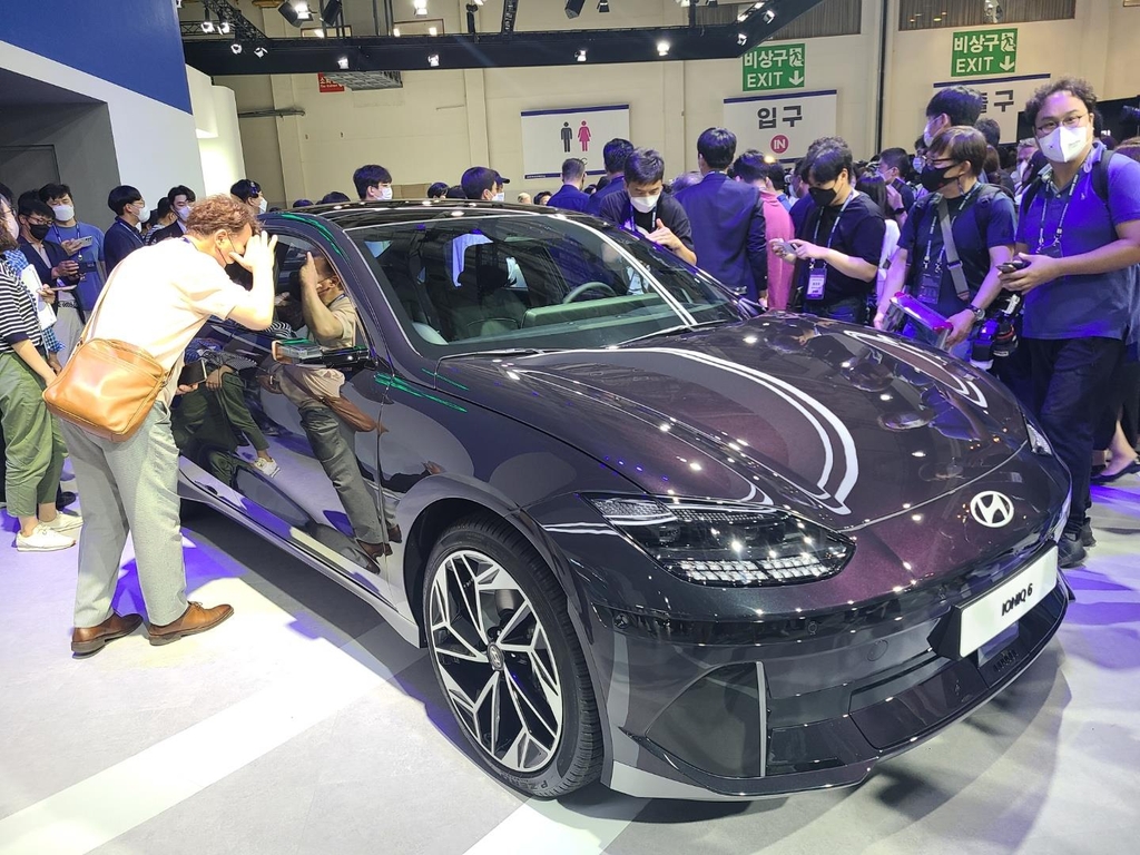 This photo taken July 14, 2022, shows reporters taking a look at Hyundai Motor's IONIQ 6 electric sedan during the press day of the Busan Motor Show in Busan, 453 kilometers south of Seoul. (Yonhap)