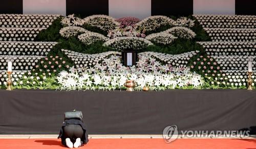 A person is on his knees at a mourning altar at Seoul Plaza in Seoul on Oct. 31, 2022. (Yonhap)