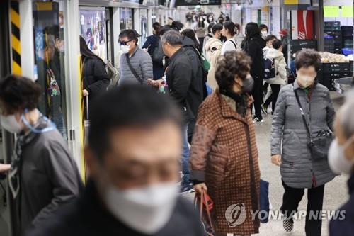 People wear masks at a subway station in Seoul, in this file photo taken March 5, 2023. (Yonhap)