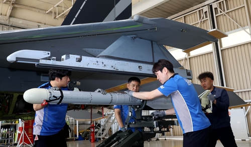 Los trabajadores de Korea Aerospace Industries Ltd. (KAI) equipan un misil aire-aire AIM-2000 simulado en el ala de un prototipo KF-21 en un hangar en la sede de la compañía en Sacheon, 437 kilómetros al sur de Seúl, el 9 de mayo de 2019. 2023. (Foto de grupo) (Yonhap)