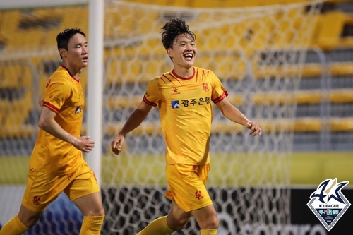 In this Aug. 4, 2023, file photo provided by the Korea Professional Football League, Jung Ho-yeon of Gwangju FC (R) celebrates after scoring against Daejeon Hana Citizen FC during a K League 1 match at Gwangju Football Stadium in the southwestern city of Gwangju. (PHOTO NOT FOR SALE) (Yonhap)