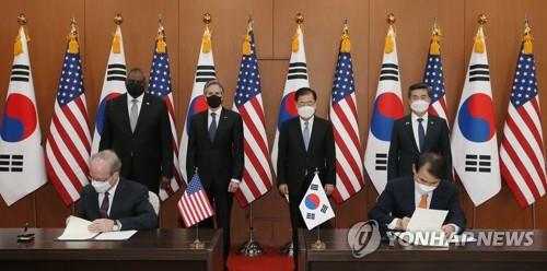 En esta foto de archivo, el entonces principal negociador de Corea del Sur, Jeong Eun-bo (derecha, sentado), y Rob Rapson, entonces embajador en funciones de Estados Unidos en Seúl, (izq., sentado) rubrican un acuerdo sobre la parte que le corresponde a Seúl del costo del estacionamiento de los 28.500 soldados. -Fuertes Fuerzas estadounidenses en Corea, denominada Acuerdo de Medidas Especiales, en una ceremonia de firma en el Ministerio de Asuntos Exteriores en Seúl el 18 de marzo de 2021. (Foto de la piscina) (Yonhap)