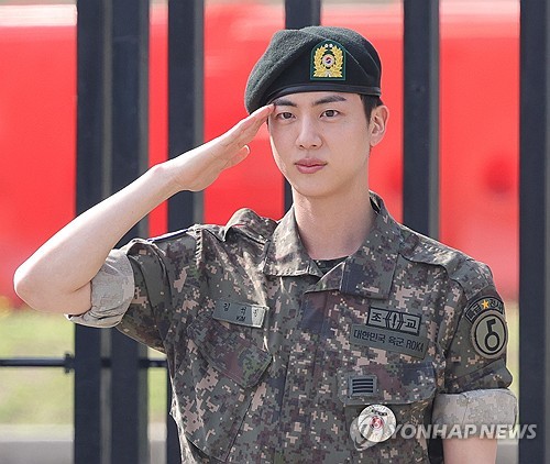 BTS member Jin salutes at the main gate of the 5th Army Infantry Division in Yeoncheon, 61 kilometers north of Seoul, on June 12, 2024, after completing his mandatory military service. (Yonhap)