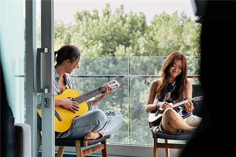 A still from "Because I Hate Korea," provided by D Station on Aug. 27, 2024, shows Gye-na playing a guitar in New Zealand. (PHOTO NOT FOR SALE) (Yonhap)