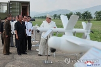 (LEAD) N. Korea's Kim orders mass production of suicide attack drones: KCNA