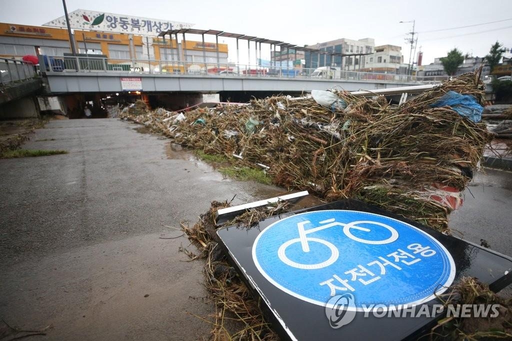Des panneaux et déchets sont éparpillés par terre à Gwangju, dans la province du Jeolla du Sud, le lundi 10 août 2020, suite à des pluies torrentielles.