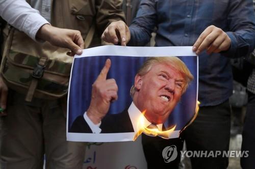 2018년 미국이 핵합의를 탈퇴하자 트럼프 미국 대통령 사진을 불태우는 이란의 반미 시위대. [EPA=연합뉴스 자료사진]