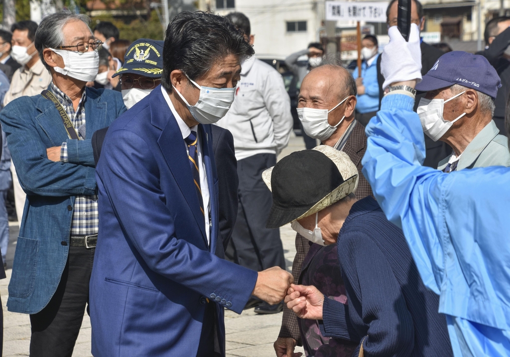 (시모노세키 교도=연합뉴스) 아베 신조 전 일본 총리가 19일 중의원 선거 후보 등록을 마친 뒤 지역구인 야마구치현 시모노세키에서 지지자들과 인사를 나누고 있다. 