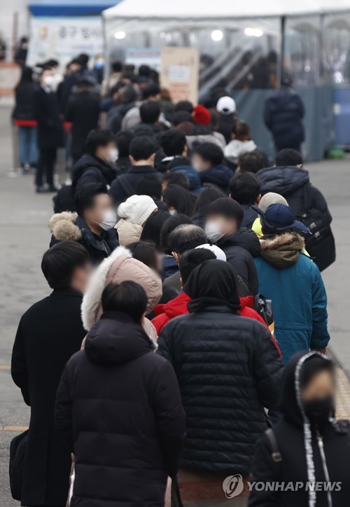 En la foto de archivo, las personas esperan en fila para someterse a las pruebas del COVID-19, el 24 de diciembre de 2021, en una clínica provisional, frente a la Estación de Seúl, en el centro de la capital surcoreana.