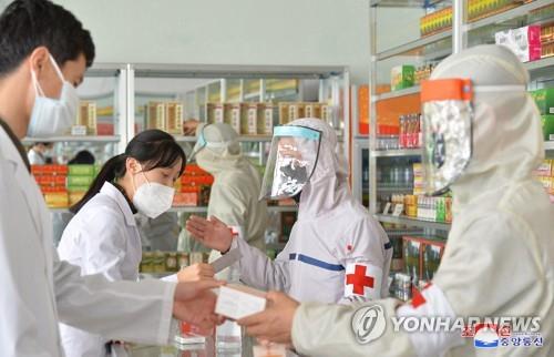 La foto, publicada, el 25 de mayo de 2022, por la KCNA, muestra a soldados norcoreanos del campo médico militar del Ejército Popular suministrando medicamentos a una farmacia en Pyongyang, en medio del brote de COVID-19 en el país. (Uso exclusivo dentro de Corea del Sur. Prohibida su distribución parcial o total)