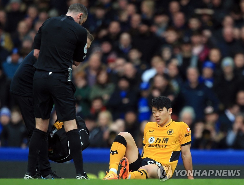 In this AFP file photo from March 13, 2022, Hwang Hee-chan of Wolverhampton Wanderers is being treated for an injury during a Premier League match against Everton at Goodison Park in Liverpool, England. (Yonhap)