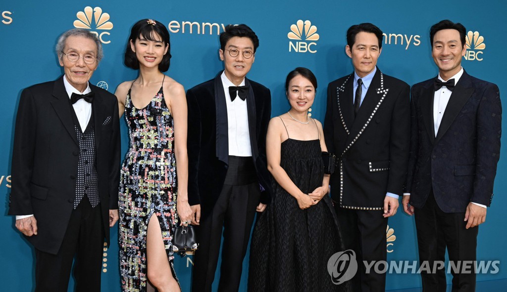 In this AFP photo, the cast and crew of "Squid Game" pose for a photo during a red carpet event for the 74th Emmy Awards at the Microsoft Theater in Los Angeles, California, on Sept. 12, 2022. (Yonhap)
