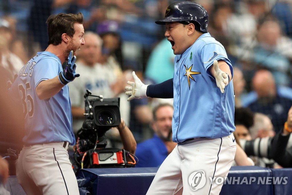 In this Getty Images photo, Choi Ji-man of the Tampa Bay Rays (R) celebrates with teammate Brett Phillips after hitting a solo home run against the New York Yankees during the bottom of the second inning of a Major League Baseball regular season game at Tropicana Field in St. Petersburg, Florida, on May 29, 2022. (Yonhap)