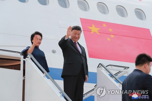 Xi, wife wave before departure