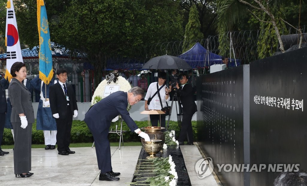 South Korean President Moon Jae-in burns incense in front of a stone monument for the South Korean victims of a 1983 bombing attack by North Korean agents during his visit to the Martyrs' Mausoleum in Yangon, Myanmar, on Sept. 4, 2019. First lady Kim Jung-sook stands behind him. (Yonhap)